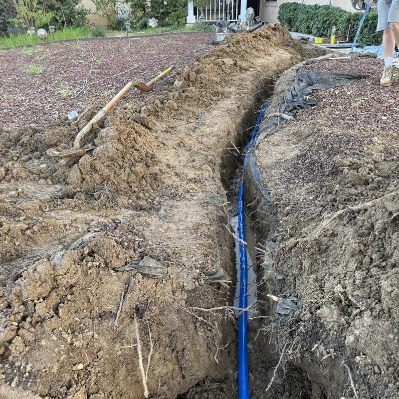Main water line installation in front yard trench