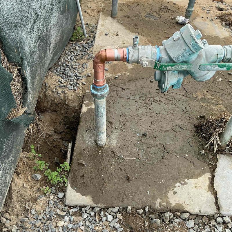 Copper water service pipe and backflow valve assembly