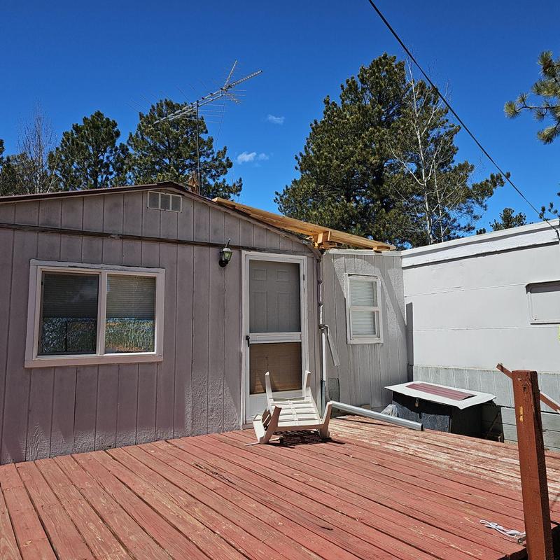 Wood deck with damaged chair near exterior wall Wood deck with damaged chair near exterior wall