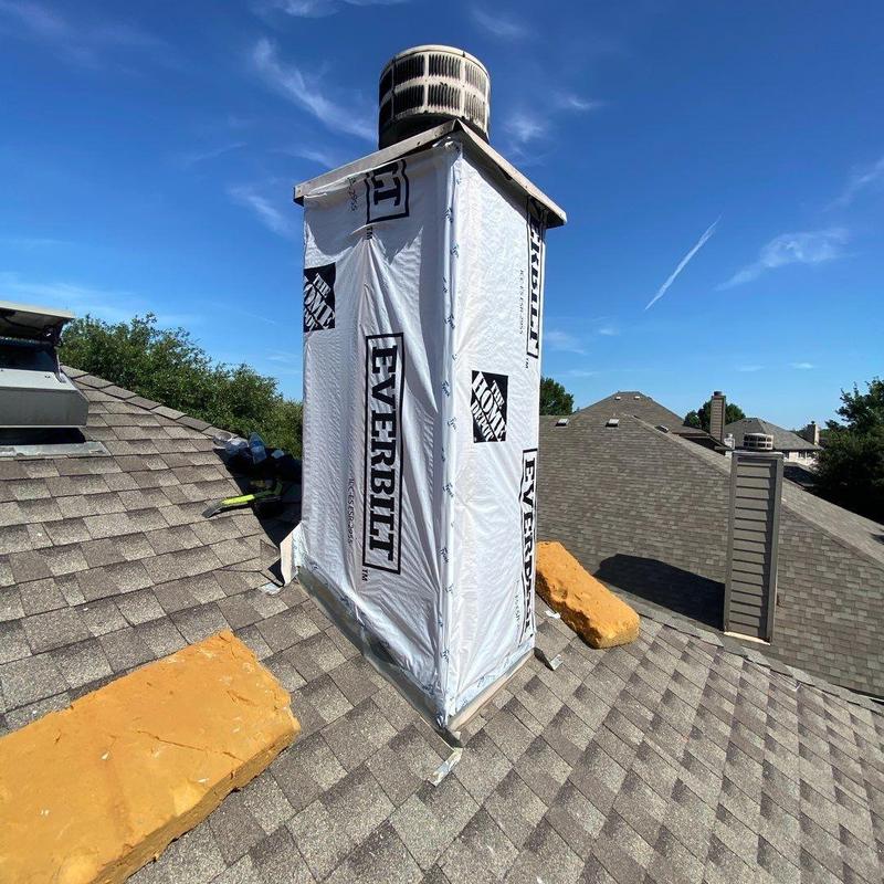 Chimney chase with new vapor barrier installation on roof Chimney chase with new vapor barrier installation on roof