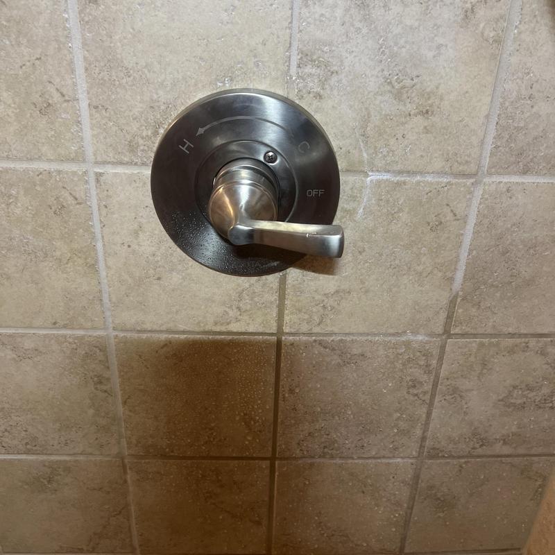 Single handle shower valve on tiled wall in bathroom