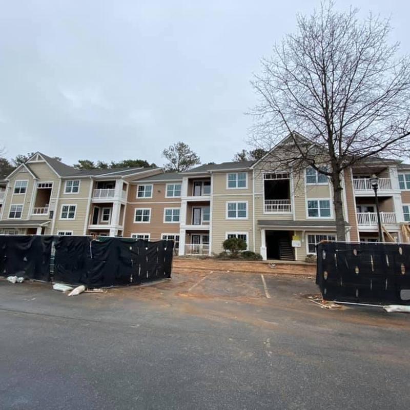 Asphalt shingle roof on damaged apartment building Asphalt shingle roof on damaged apartment building