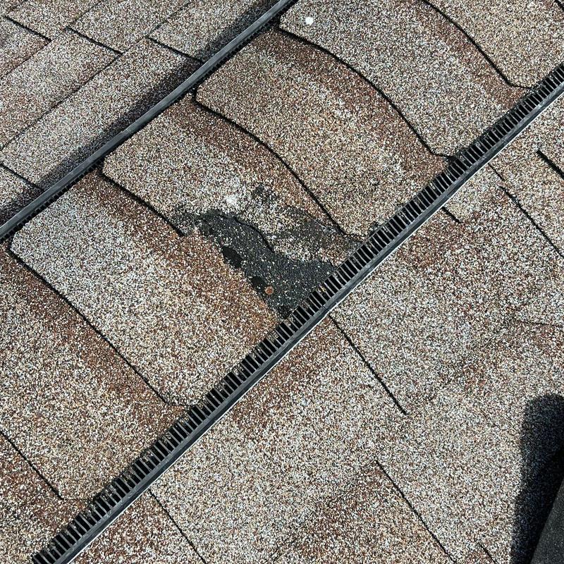 Asphalt shingles with hail damage and granule loss
