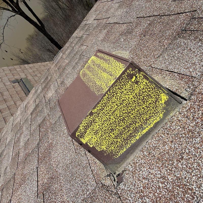 Asphalt shingle roof ventilation cover with hail damage markings