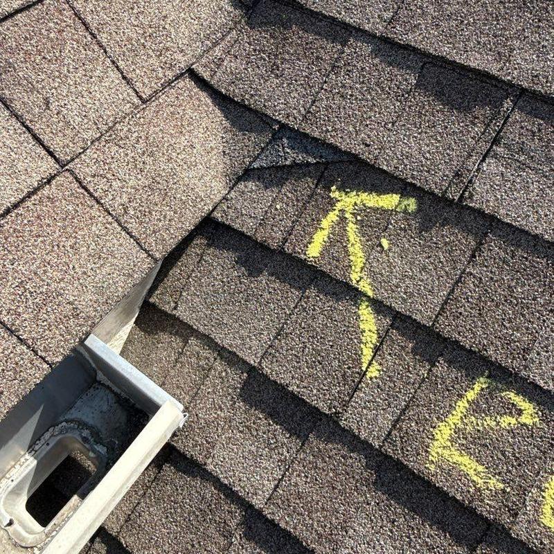 Shingle roof with marked hail damage and gutter flashings