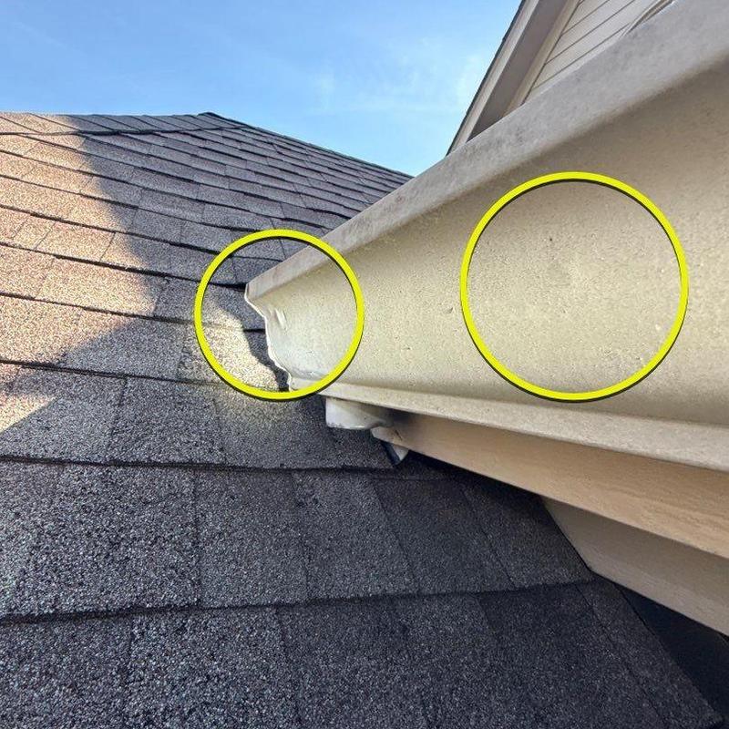 Gutter with hail damage and roof shingles