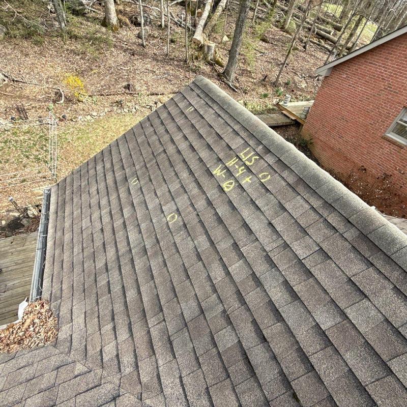 Asphalt shingle roof with hail damage markings