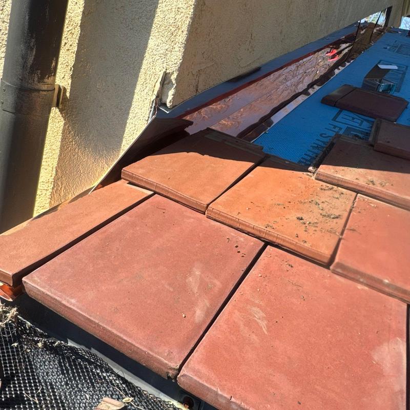 Tile roof flashing with visible wear and gaps