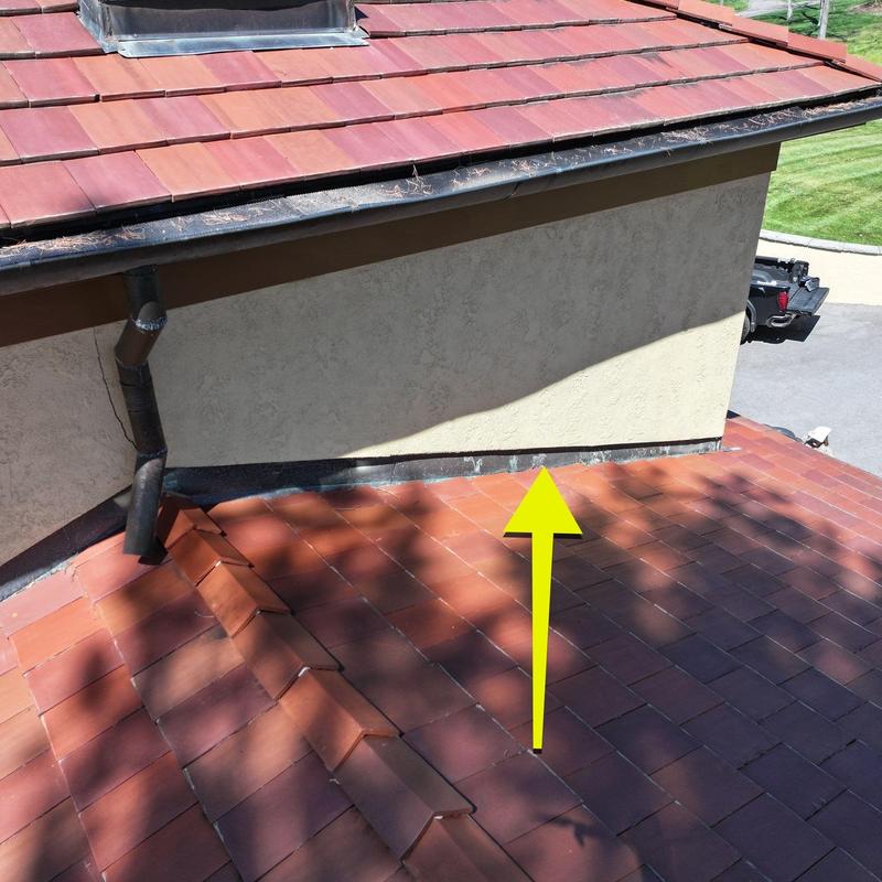 Roof flashing with hail damage on tile roof