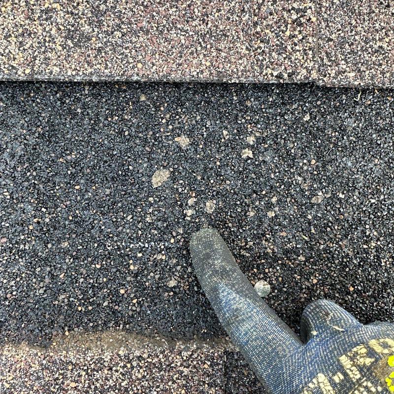 Asphalt roof shingles with hail damage spotting