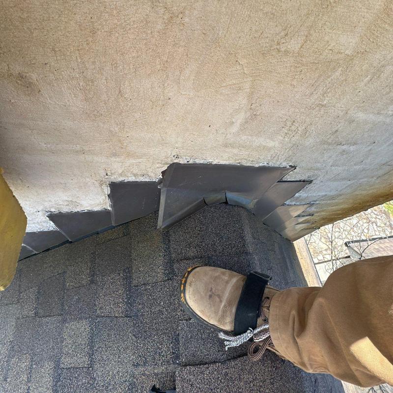 Flashing seals on roof ridge with inspection boot
