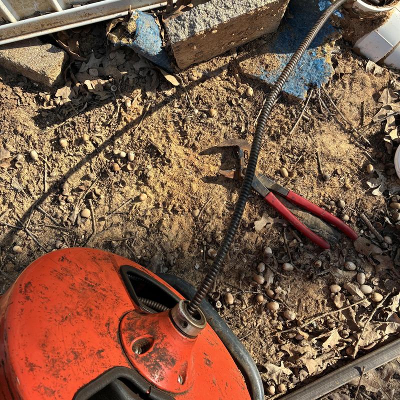 Sewer machine clearing hard stoppage at cleanout