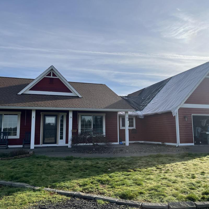 Roof valley with protective tarp covering leaks on house Roof valley with protective tarp covering leaks on house