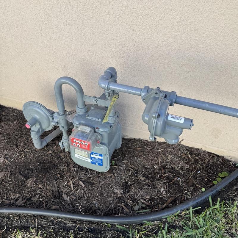 Gas regulator and meter assembly with piping