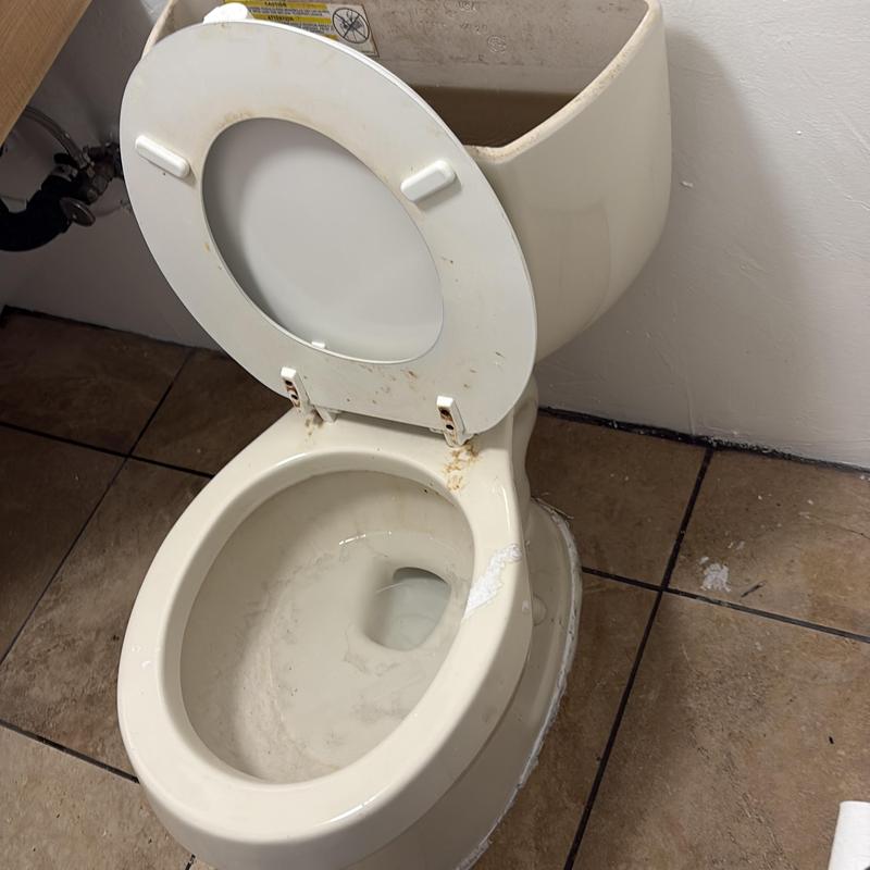Toilet with removed tank for drain access and repair