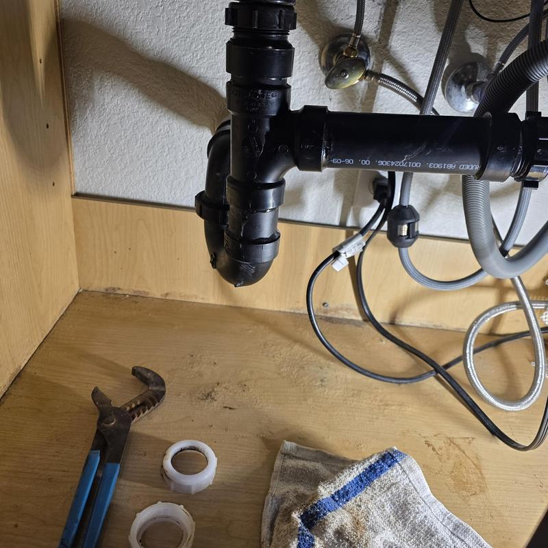 Kitchen drain trap with replacement nuts and tools