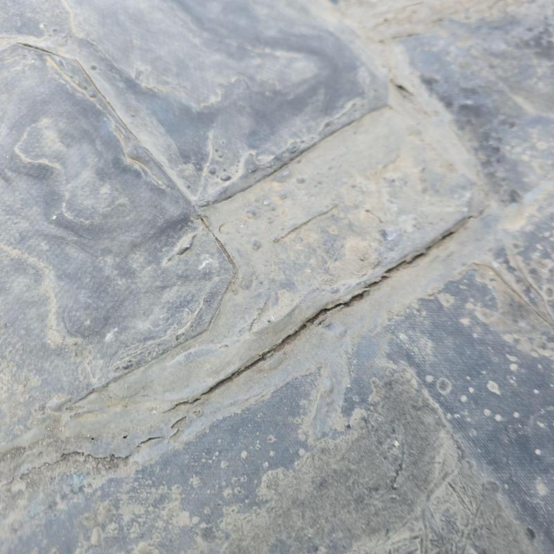 EPDM flat roof close-up showing aged damage EPDM flat roof close-up showing aged damage