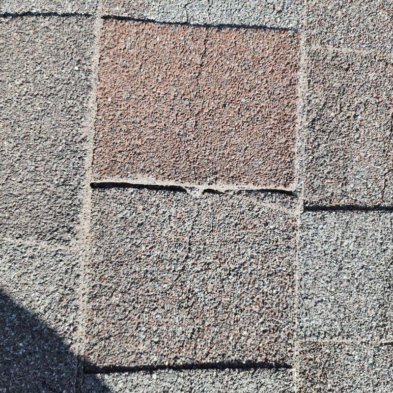 Shingle roof with cracking and weather damage close-up Shingle roof with cracking and weather damage close-up