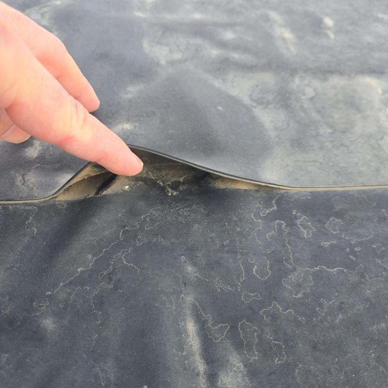 Flat roof membrane lifting with finger pointing Flat roof membrane lifting with finger pointing