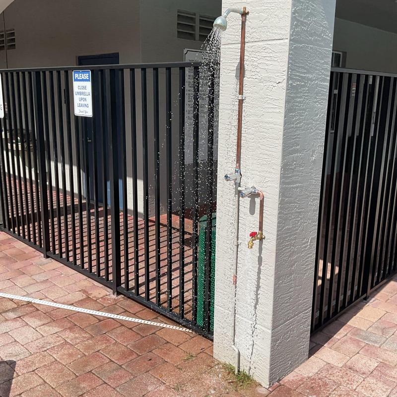 Community pool shower head with hose bib installation