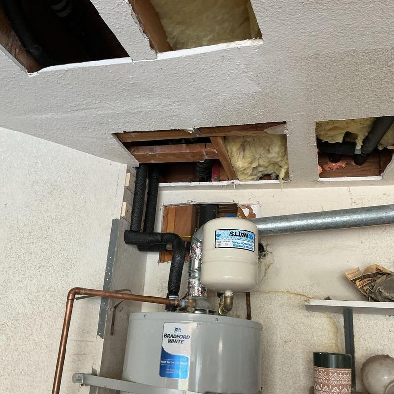 Water heater with expansion tank and ductwork above ceiling