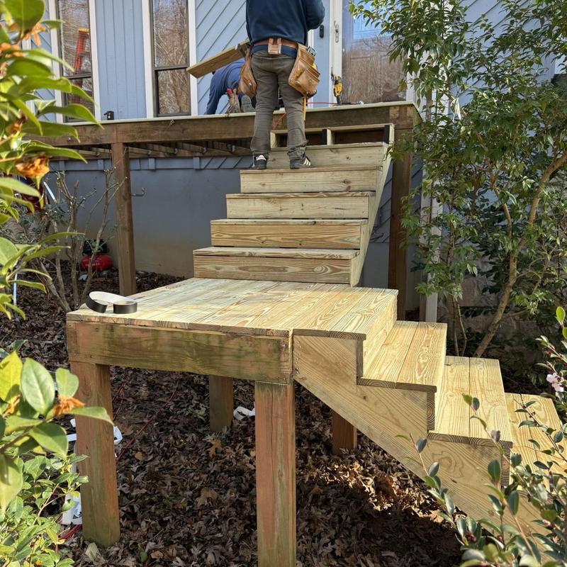 Wooden stair stringers and platform installation outdoors