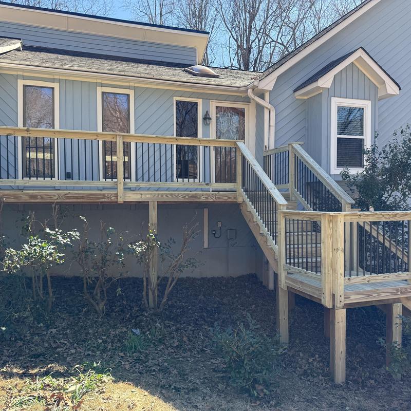 Wooden deck handrails with metal balusters and stairs