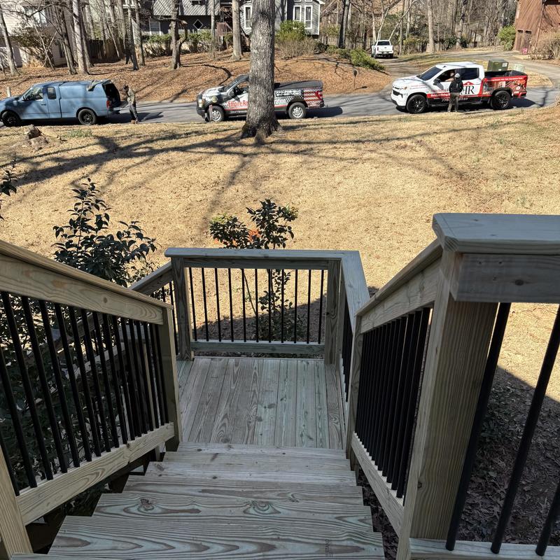 Wooden stair stringers with metal baluster handrails