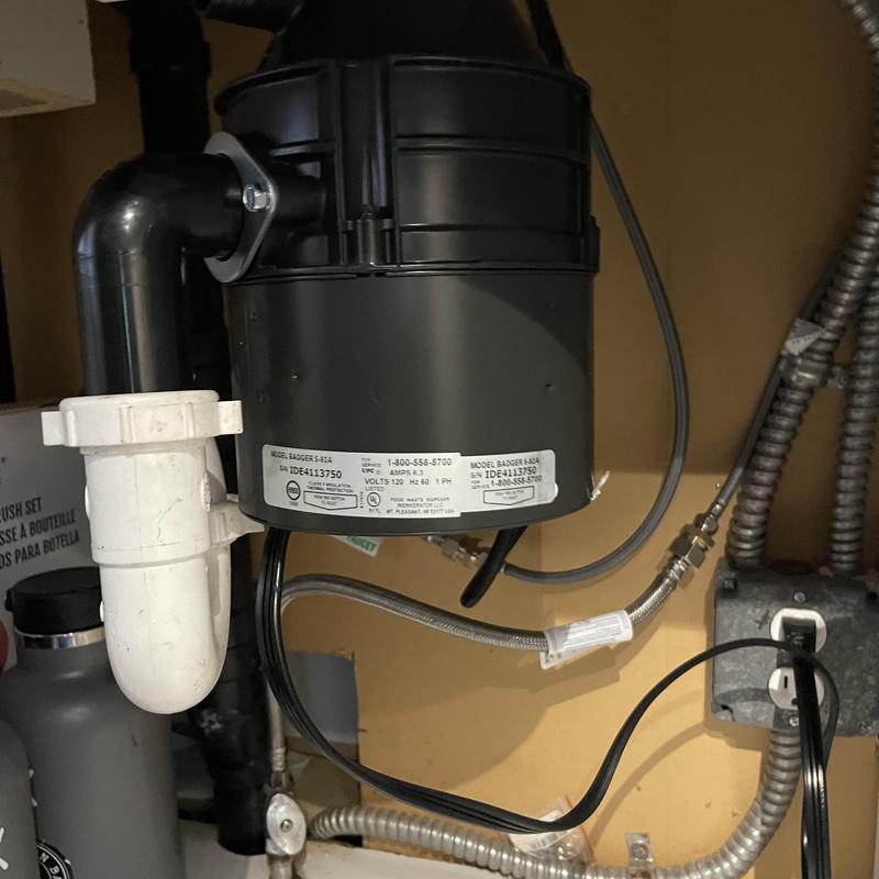Garbage disposal unit with new flange installed under sink