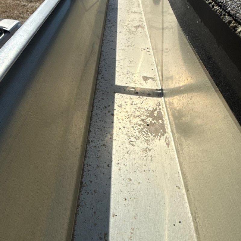 Seamless aluminum gutter with waxy buildup and shadow