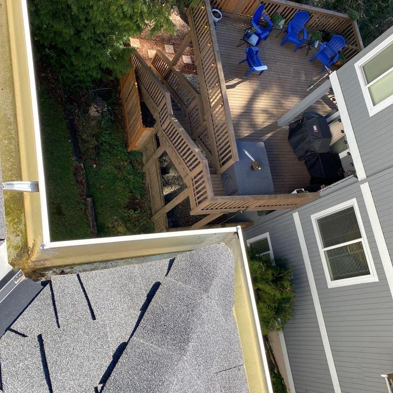 Roof gutter with leaf buildup and deck view in Arlington