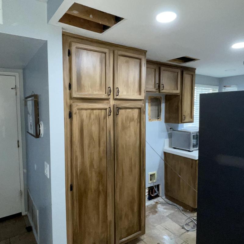 Cold water lines rerouted through kitchen cabinetry walls