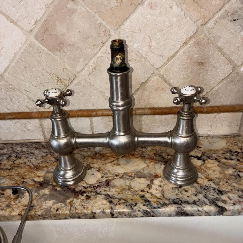 Kitchen faucet with exposed valve stem on granite counter