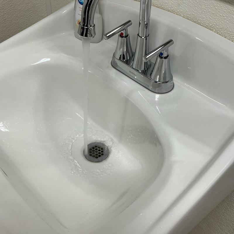 Bathroom sink faucet with running water and drain