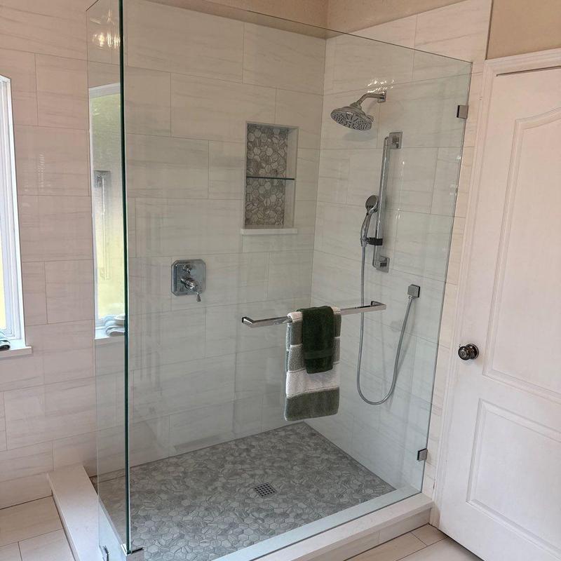 Frameless glass shower enclosure with tile flooring Frameless glass shower enclosure with tile flooring
