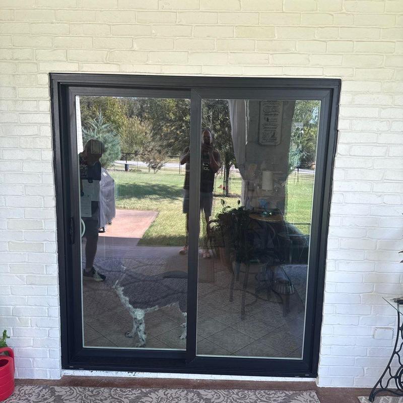Vinyl sliding glass door with black exterior and white interior