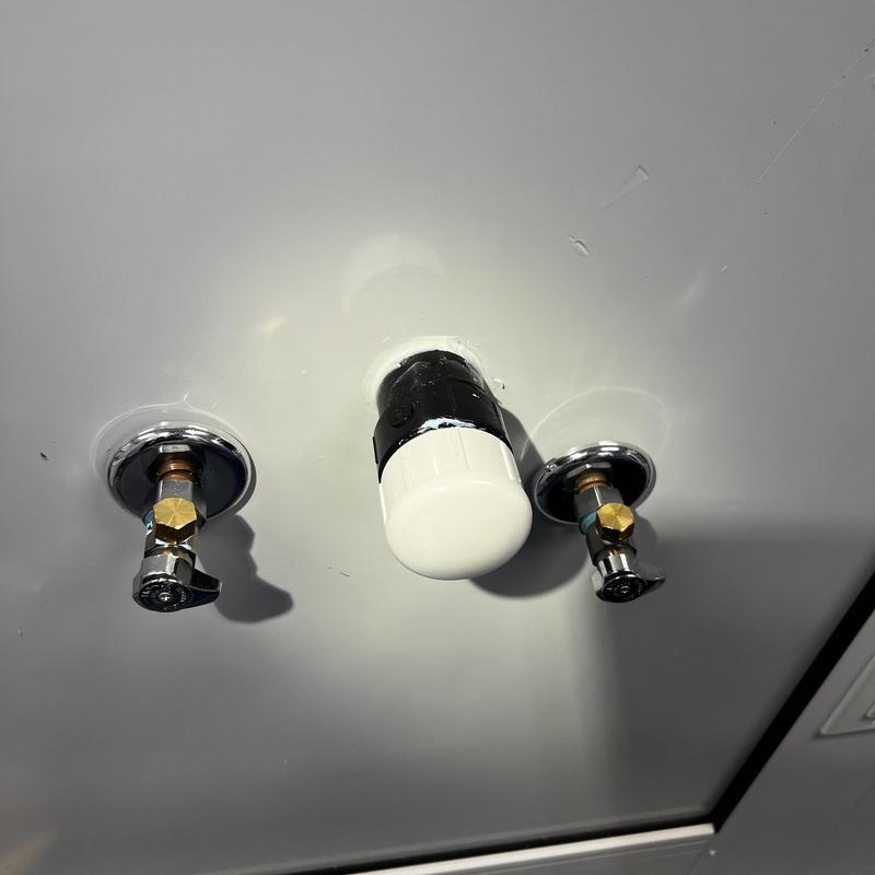 Hand sink water and drain line caps under counter