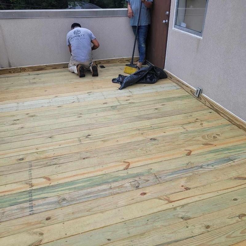 Wooden deck floor installation on flat roof townhomes