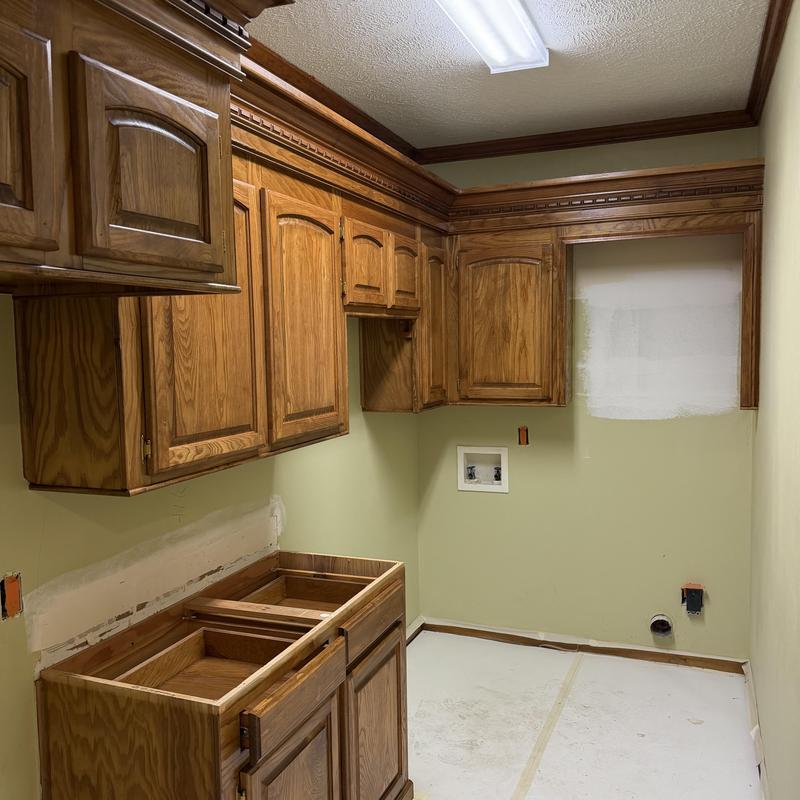 Wood cabinets and crown molding refinishing in laundry room Wood cabinets and crown molding refinishing in laundry room