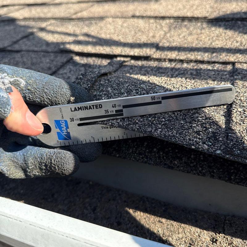 Asphalt shingle roof thickness gauge on damaged shingles