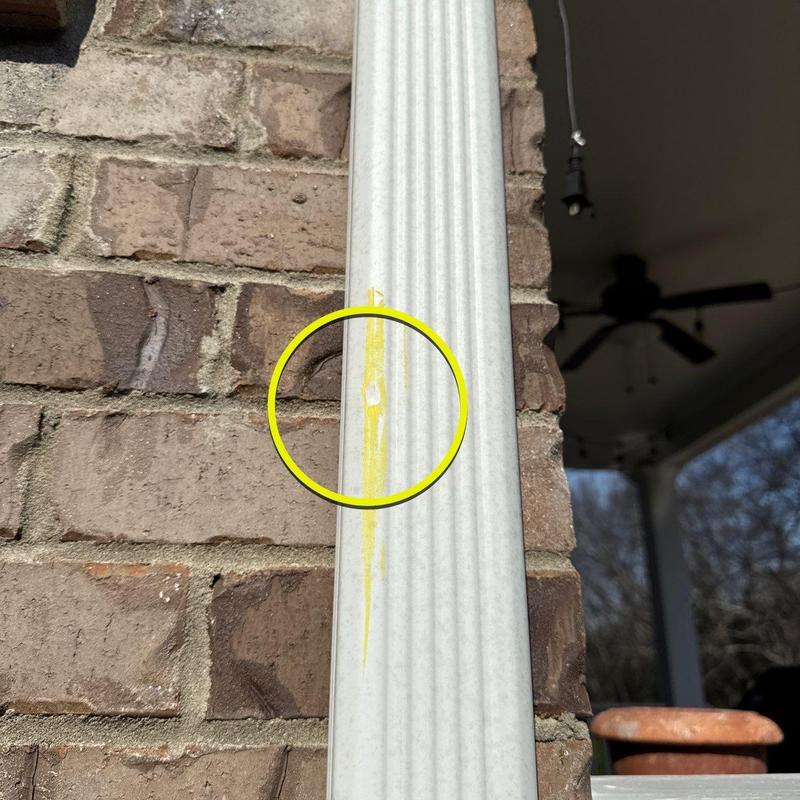 Vinyl siding with small surface damage marked in yellow