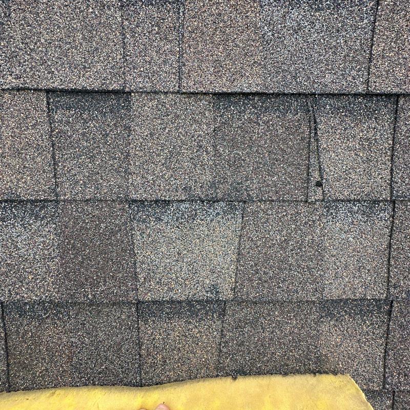 Roof shingles with visible hail damage spots