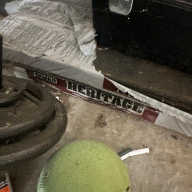 Vinyl siding corner trim damaged on building exterior