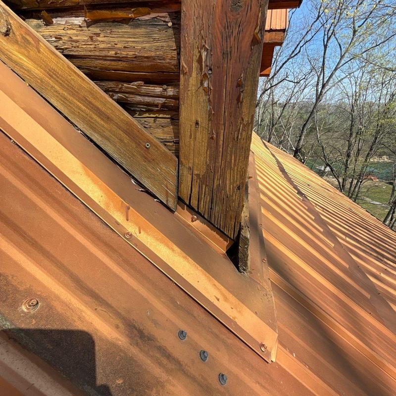 Metal roof flashing around wooden chimney post