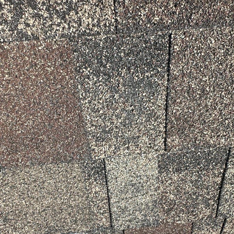 Roof shingles with visible hail damage granules