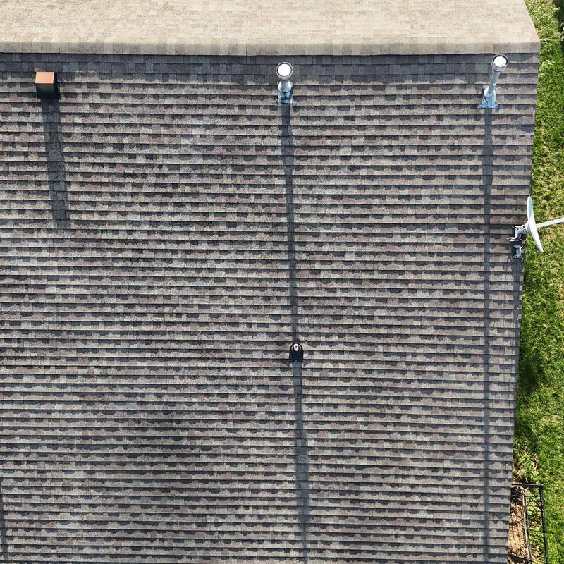 Asphalt shingle roof with vent pipes and satellite dish