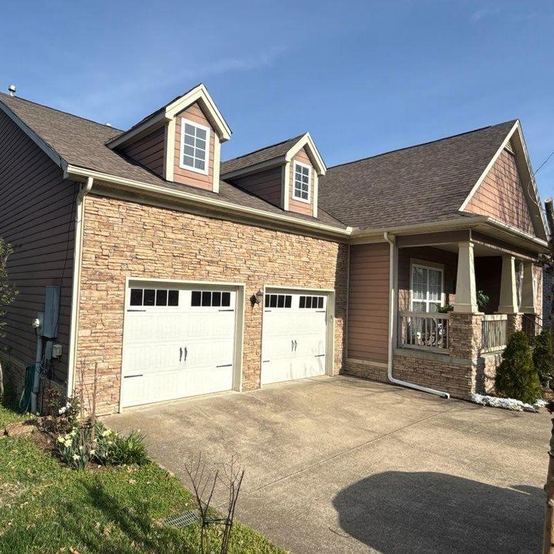 Asphalt shingle roof with dormers and garage doors