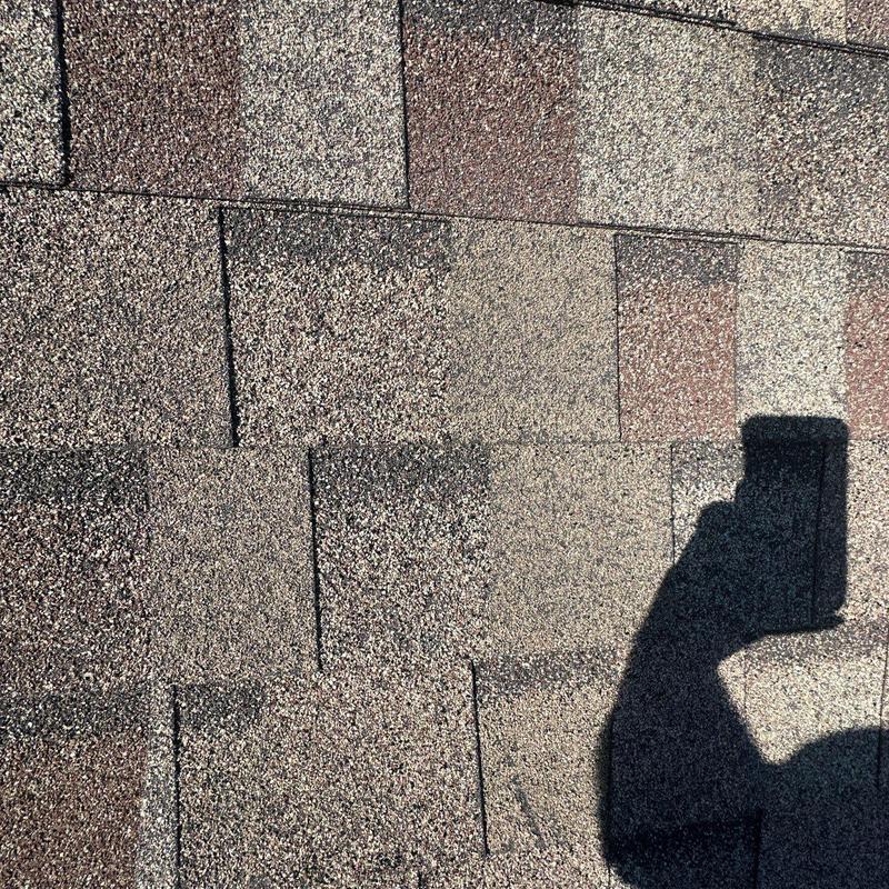 Asphalt shingles with hail damage and wear