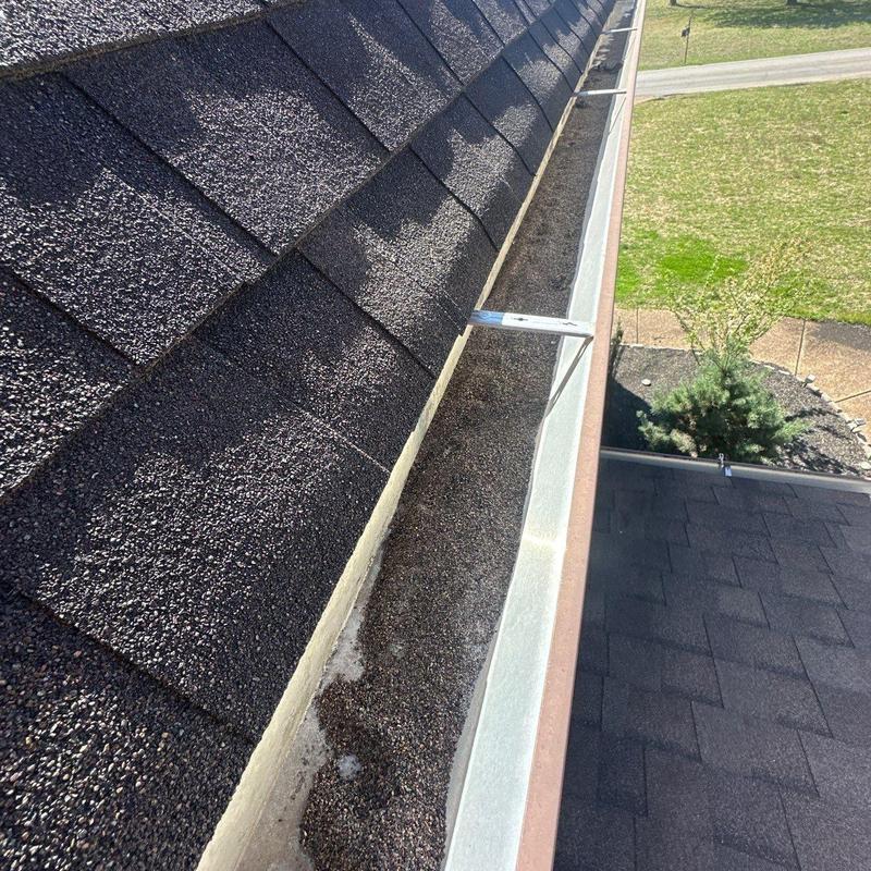 Asphalt shingle roof and debris-filled gutter inspection