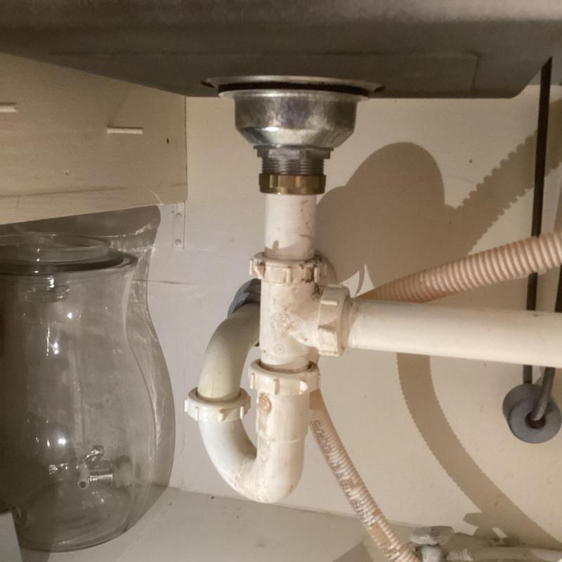 Kitchen sink basket strainer and drain pipes under sink